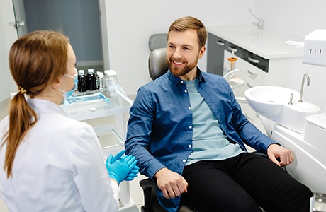 Dentist and patient having friendly conversation