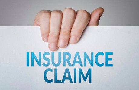 Hand holding insurance claim document