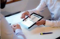 Two people looking at dental insurance information on a tablet