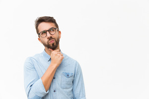 Man with glasses and light blue shirt thinking
